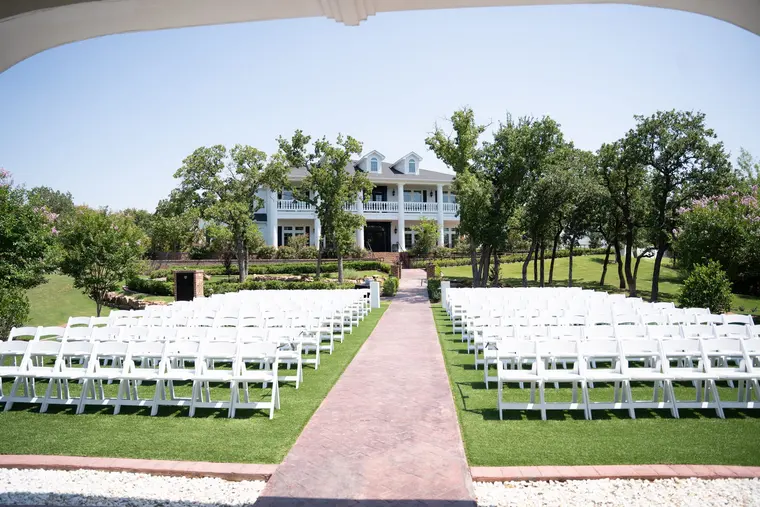 The ceremony lawn, chairs set and the aisle laid