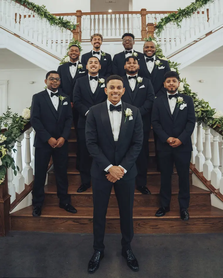 The groom and his groomsmen on the staircase