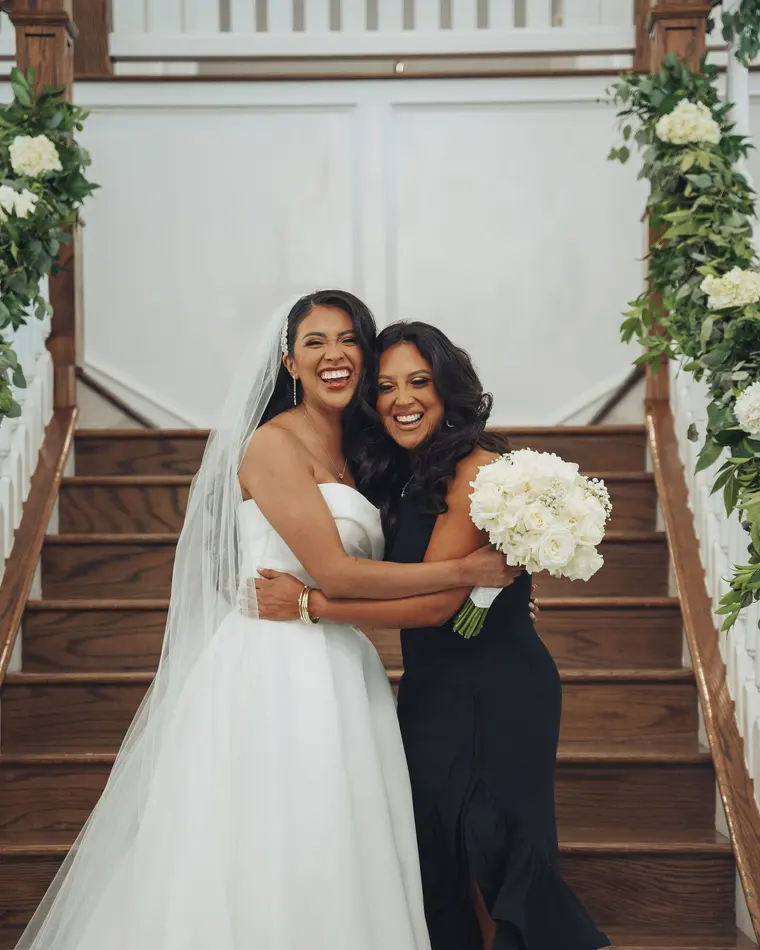 Laughing with a bridesmaid on the staircase