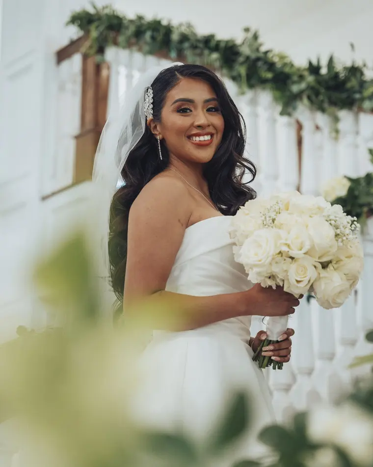 The bride, framed by greenery