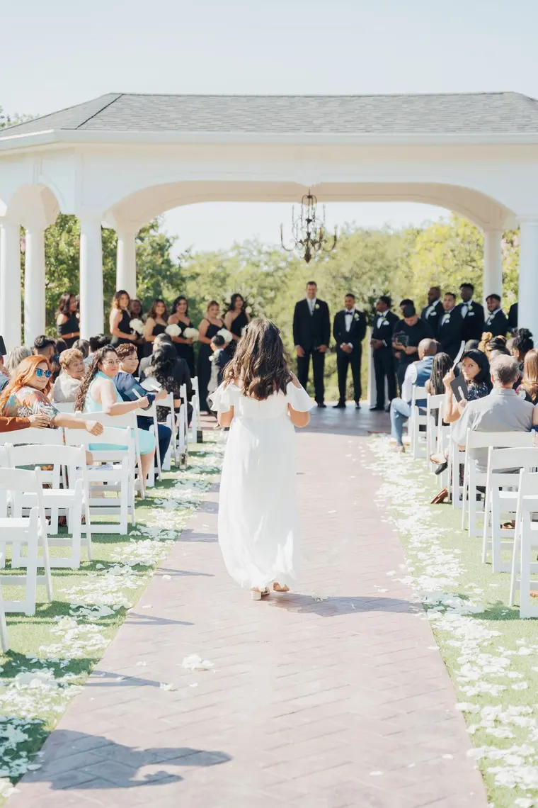 Walking the petal-strewn aisle before the ceremony