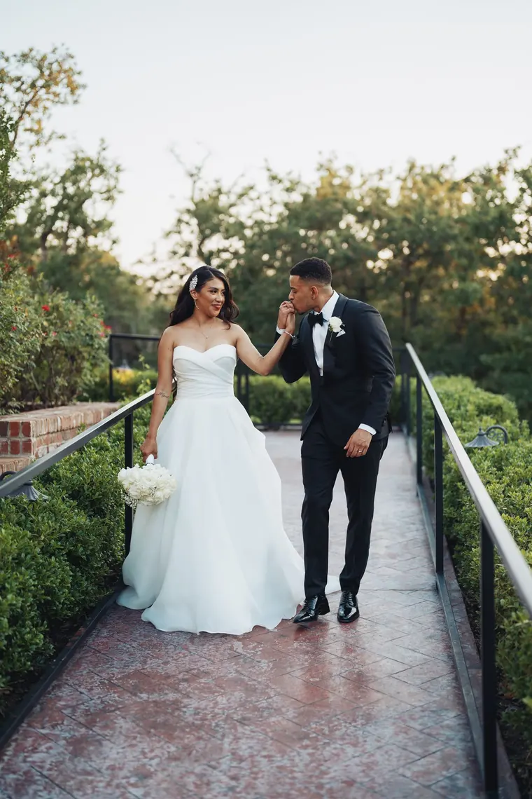 A kiss on her hand, on the garden path
