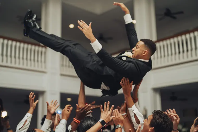The groom, airborne over the crowd